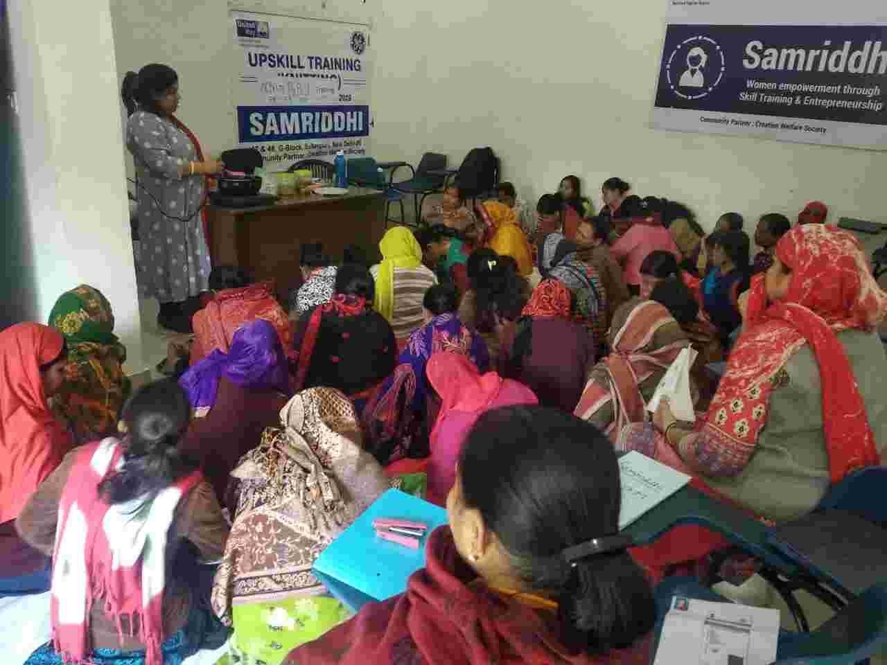 Women seated closely together in a classroom during an upskilling session.